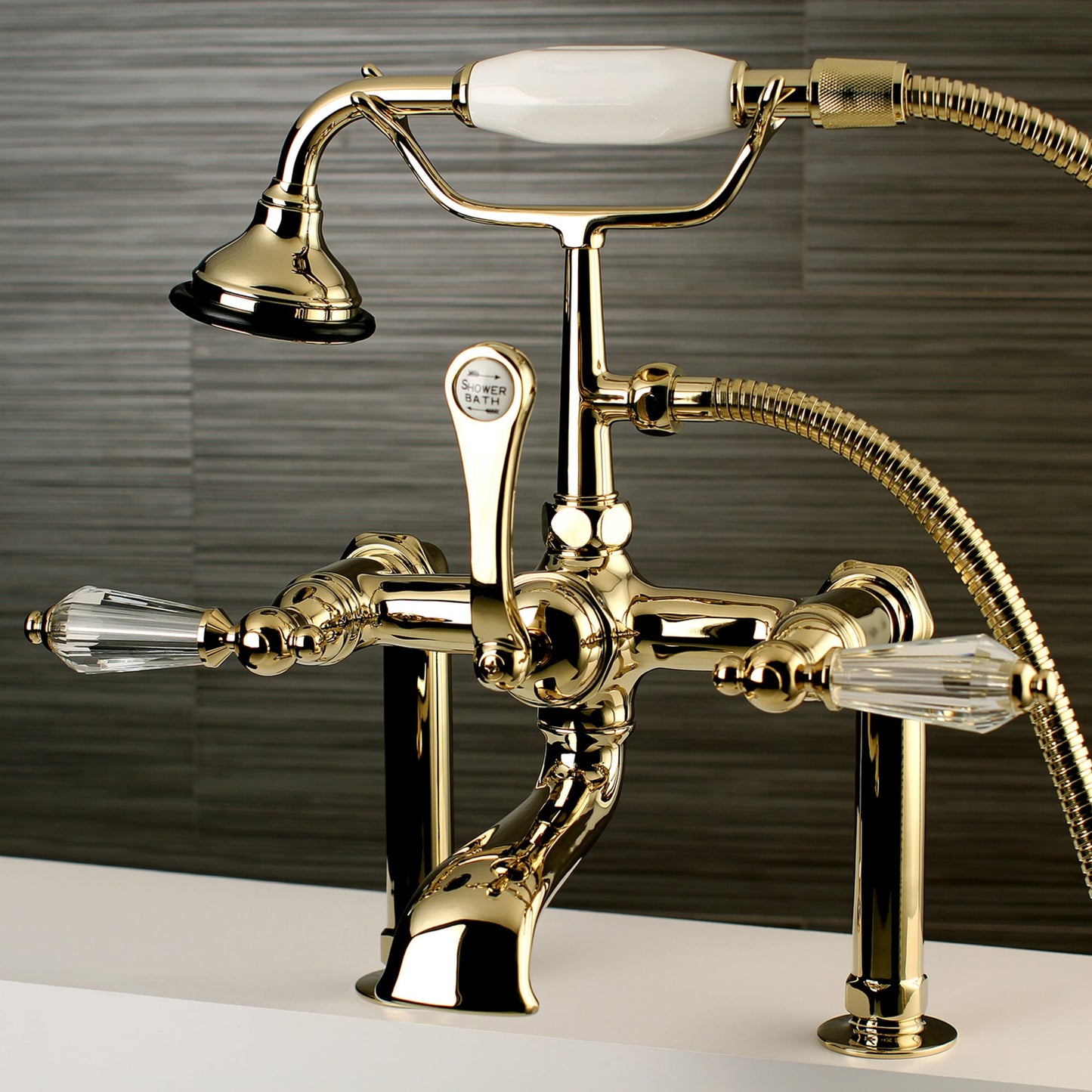 Kingston Brass Wilshire Polished brass 3-handle Deck-mount Roman Low-arc Bathtub Faucet with Hand Shower ( Valve Included )